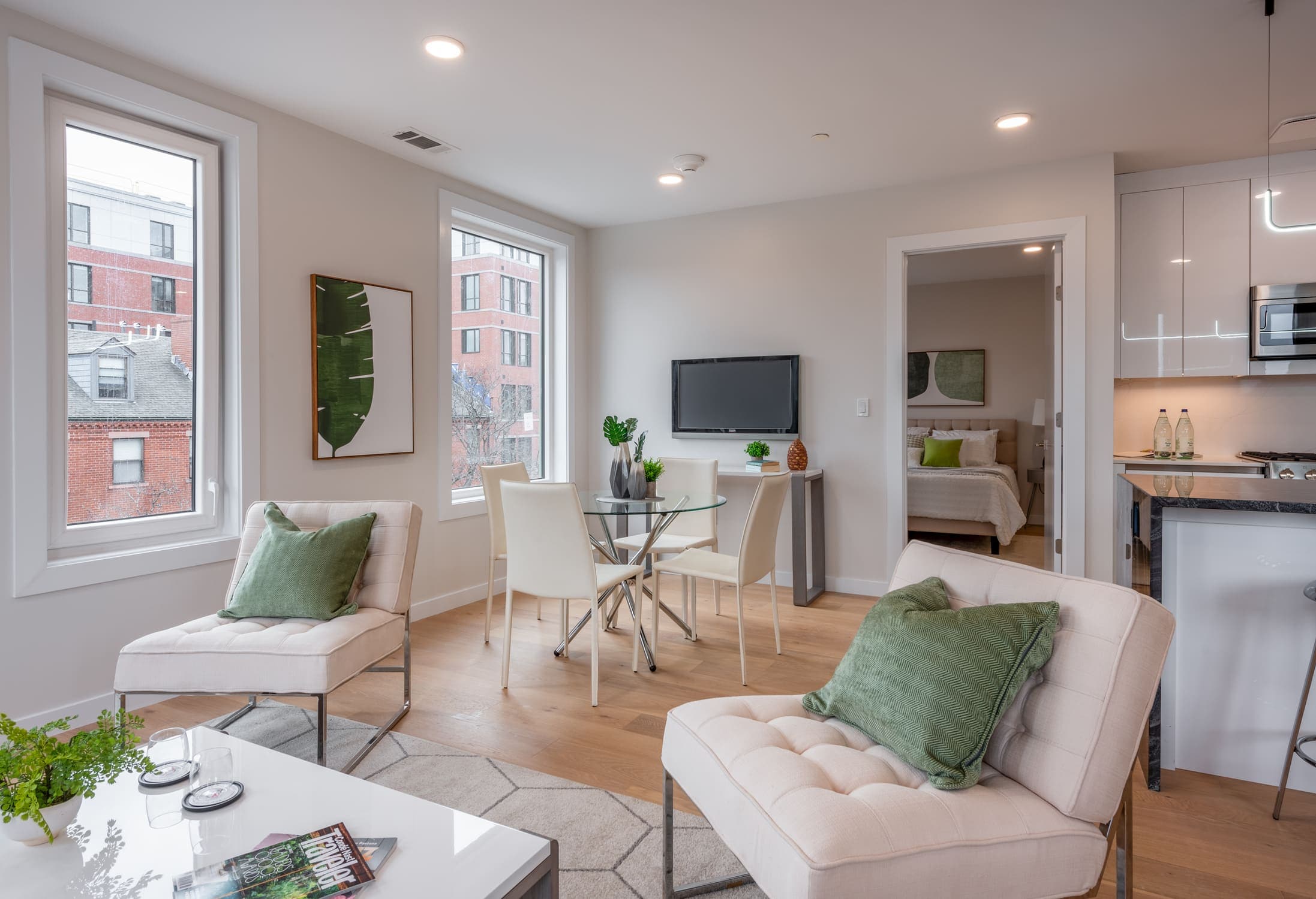 Other side of living room with TV and armchairs