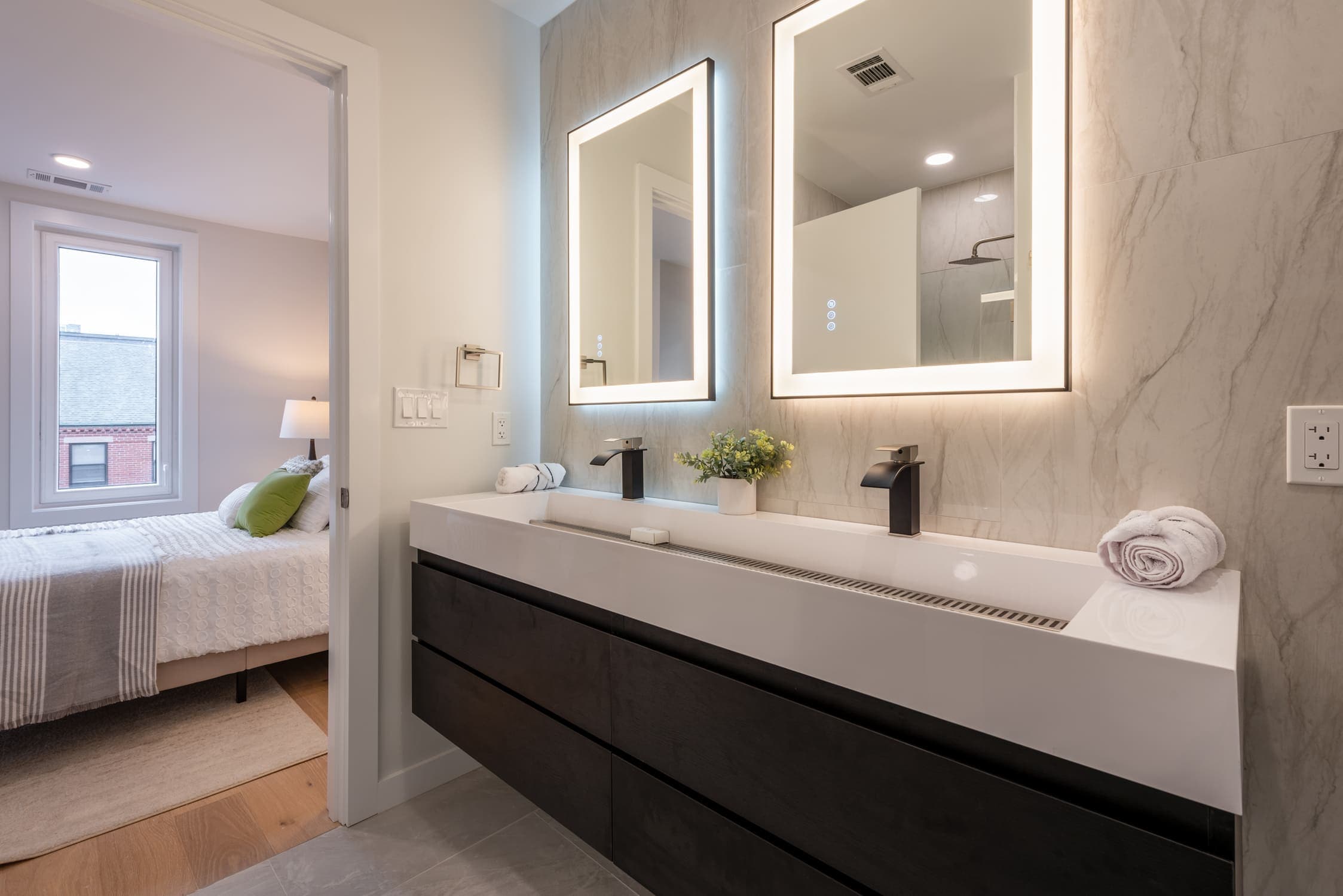Bathroom diagonal view of double sink and mirrors