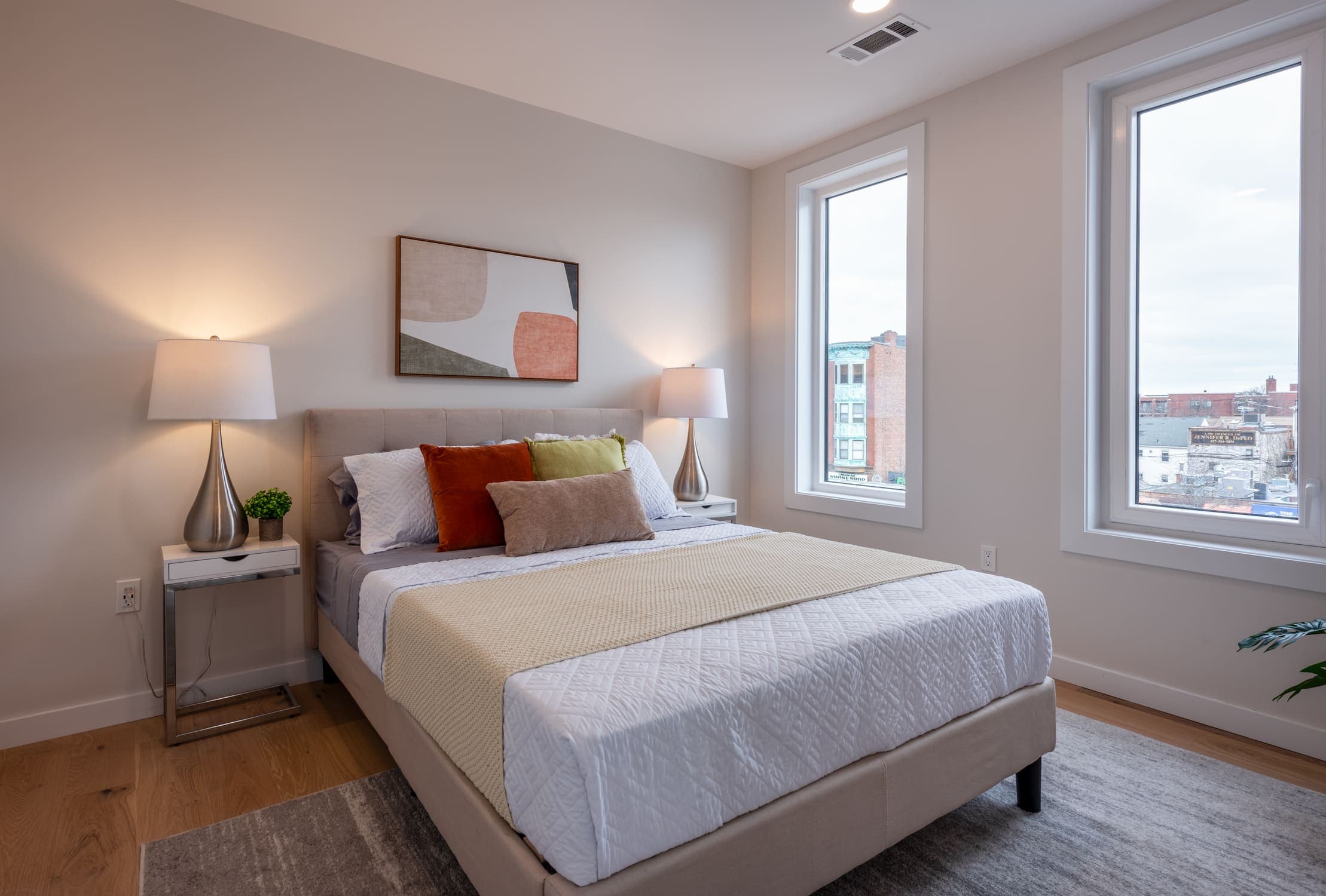 Bedroom view with bed and two windows