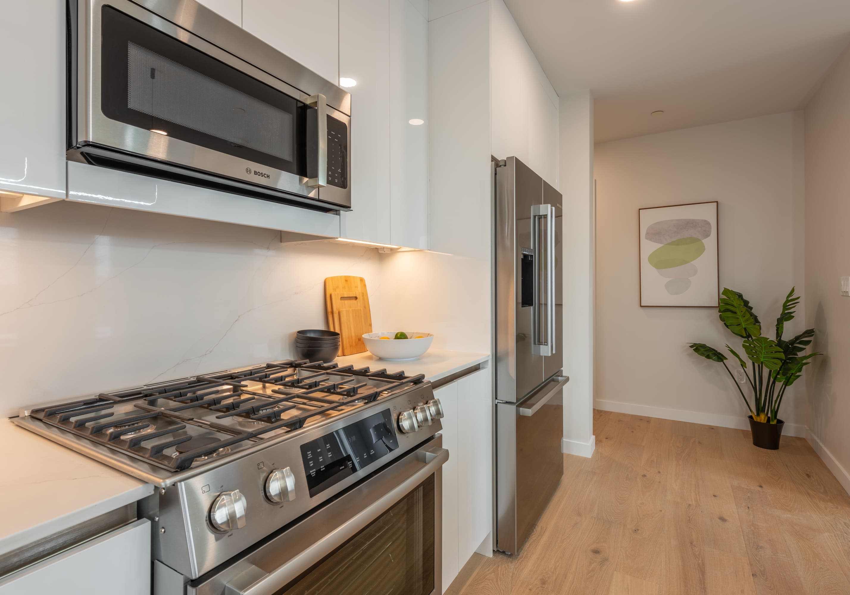 Kitchen from the corner showing stove and fridge