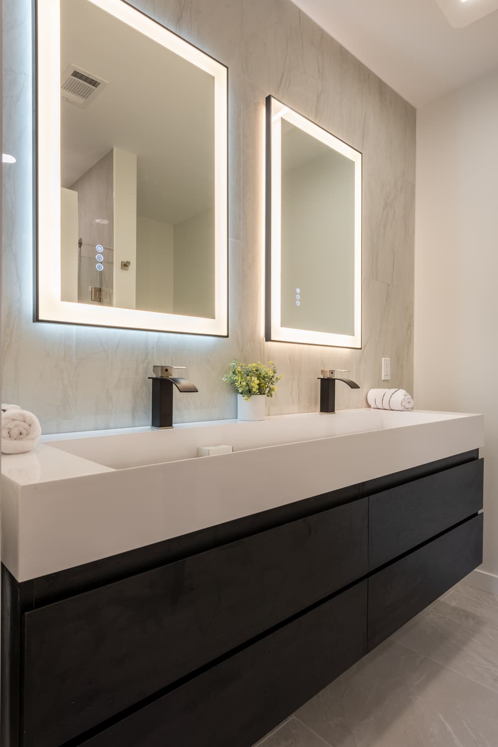 Bathroom with two sinks, two mirrors and cabnets