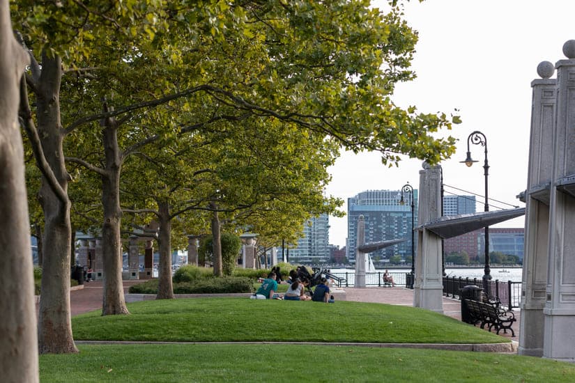 People on the grass by the river